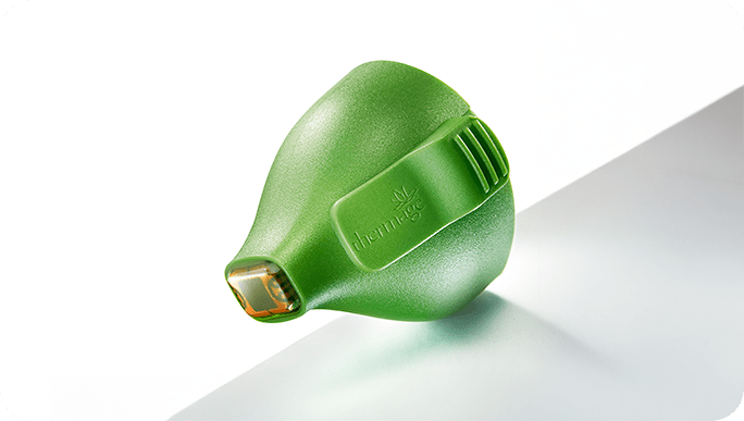 Green Thermage treatment tip with gold contact surface in close-up view